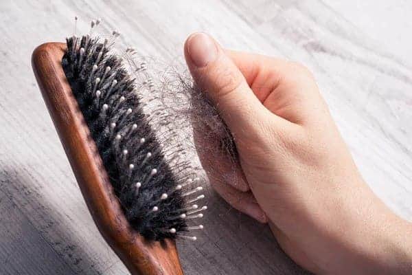 hair transplant shedding hair on comb