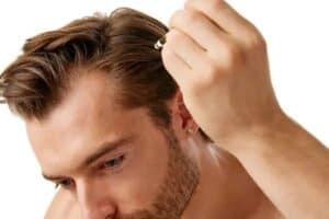 man using topical hair loss medication